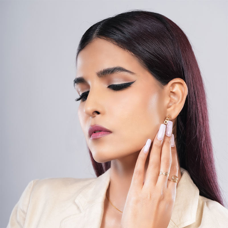 Model wearing bold eye makeup with vibrant eyeshadow.